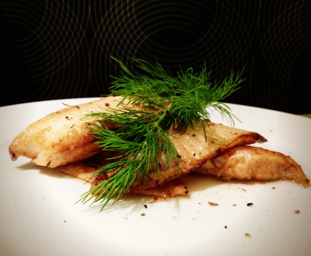 Lightly seared tilapia with a pinch of garden herbs and garnished with fresh dill